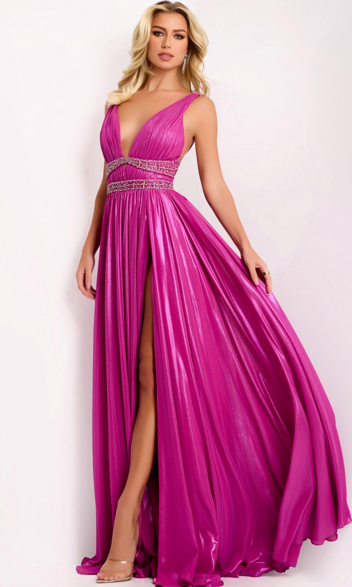 A woman models the Jovani 42817 long prom dress—a sleeveless, floor-length fuchsia gown with a high slit and beaded waistband—against a plain light background.